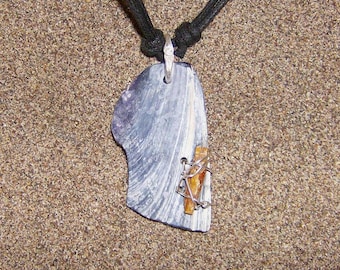 Light Wing- This Shell Amulet features a water polished Shell Fragment with a small blade of Orange Kyanite wired onto it