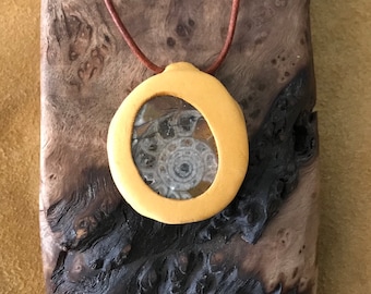 Leather and Fossil Spirit Amulet- SPIRAL WINDOW features a slice of Fossil Ammonite that is set in a golden tone leather setting.