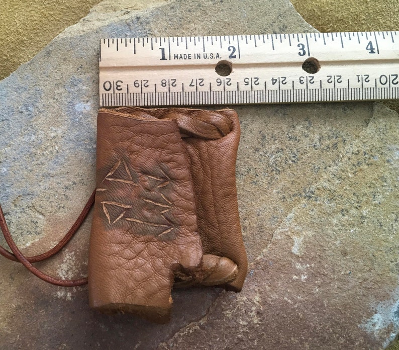 Communication...This Wisdom Pouch is made out of a warm toasty Brown Deerskin Leather and it features a hand carved symbol.