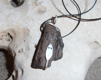Wood Snake- This pendant features a piece of Petrified Wood that has a Silver Snake coiled around it.