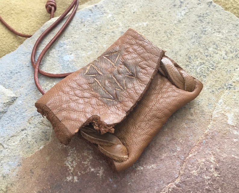 Communication...This Wisdom Pouch is made out of a warm toasty Brown Deerskin Leather and it features a hand carved symbol.