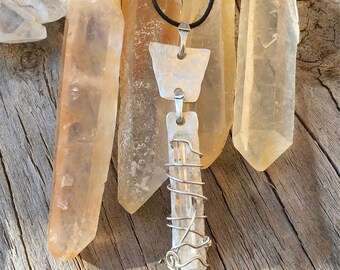 Silver and Quartz Pendant- BEACON...This unique pendant features hand hammered Silver with a Clear Quartz point that  wired onto it.