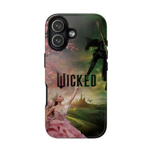 May include: A phone case featuring a scene from the musical "Wicked." The design includes the word "Wicked" in green and black, a green-skinned witch, and a woman in a pink dress. The background shows a castle and a green landscape.