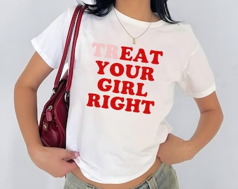 May include: White t-shirt with the text "TREAT YOUR GIRL RIGHT" in red and pink lettering. The shirt is a classic crew neck style.