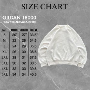 May include: A cream-colored Gildan 18000 heavy blend sweatshirt with a size chart. The chart lists sizes S to 5XL, with measurements in inches for width, length, and sleeve length. The sweatshirt is displayed on a gray background.