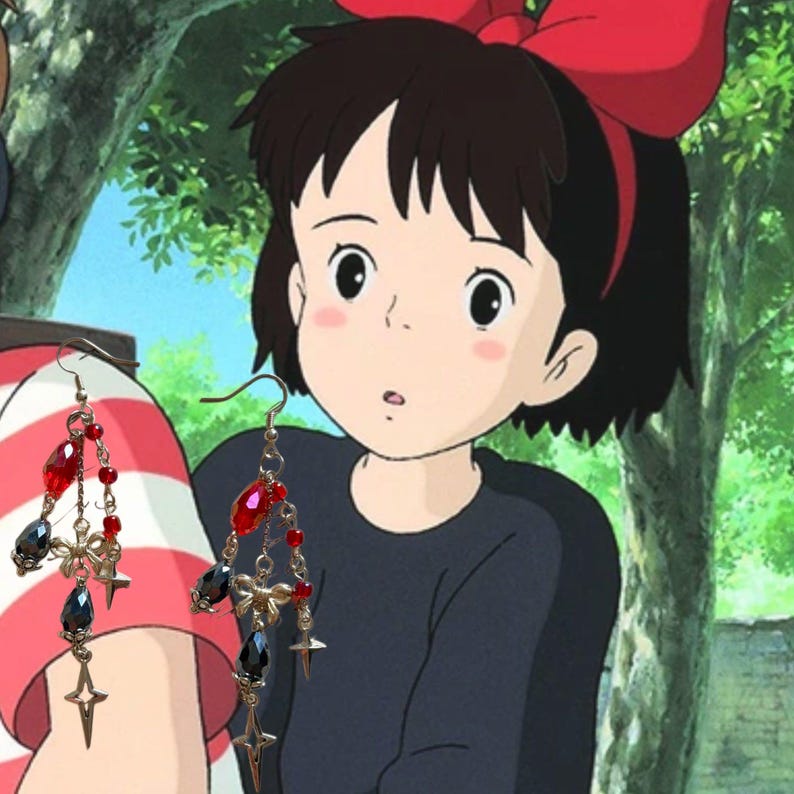 May include: Dangling earrings with red and black beads, small star charms, and bow accents. The earrings are set against a cartoon background featuring a girl with a red bow.