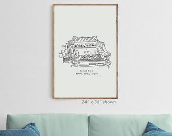 May include: A framed black and white line drawing of Stamford Bridge stadium, with the word "CHELSEA" at the top. The text "24" x 36" shown" is at the bottom. The artwork is displayed on a light green background.