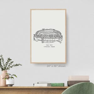 May include: A black and white line drawing of M&T Bank Stadium, home of the Baltimore Ravens, in Baltimore, Maryland. The stadium is shown from an aerial view. The text "M&T Bank Stadium, Baltimore, Maryland" is below the drawing.