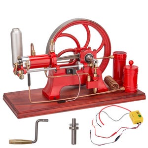 May include: A red and silver model steam engine with a large flywheel, cylinders, and copper tubing, mounted on a wooden base. Includes a crank, a small metal part, and a yellow electrical component with wires.