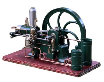 May include: A detailed model steam engine, featuring a dark green flywheel and components, copper piping, and a silver cylinder. The engine is mounted on a stained wooden base, with two green cylindrical containers. The model is a display piece.