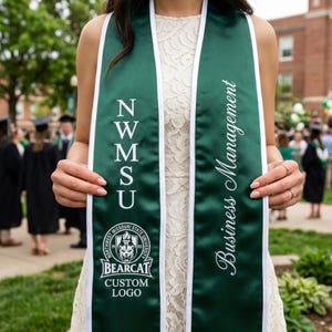 May include: A dark green graduation sash with white trim and the text "Business Management" in white script. The sash also features the letters "N W M S U" and the "Northwest Missouri State University" logo with the word "BEARCAT" and "CUSTOM LOGO".