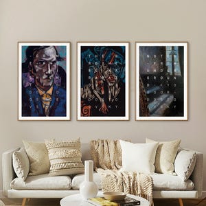 May include: Three framed art prints with text and portraits. The prints are displayed above a gray sofa with decorative pillows. The text on the prints includes "CRIME AND PUNISHMENT" and "NOTES FROM UNDERGROUND" by Dostoevsky.