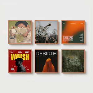 May include: Six framed art prints with various designs. The prints feature images of a person, a trumpet, and abstract designs with text. The color palette includes brown, red, orange, and green. The text includes the words "DESIRE", "VANISH", and "REBIRTH".