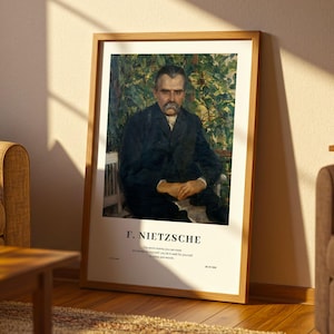 May include: A framed art print of Friedrich Nietzsche. The portrait shows Nietzsche in a dark suit, seated against a backdrop of green foliage. The print includes the name "F. Nietzsche" and a quote at the bottom, framed in a light brown wooden frame.