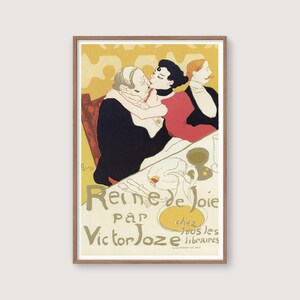 May include: A framed vintage poster titled "Reine de Joie" by Victor Joze. The artwork depicts three figures in a restaurant setting, with a couple embracing and a third person observing. The poster has a yellow and gold color scheme.