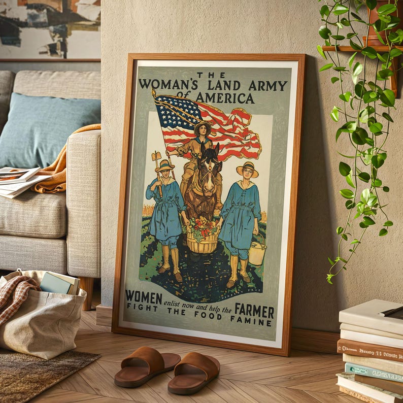 May include: A framed vintage poster with a wooden frame. The poster features an illustration of women in blue uniforms and straw hats, with an American flag and a horse. The text reads "The Woman's Land Army of America" and "Women enlist now and help the Farmer fight the food famine."