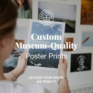 May include: A person holding a poster print with the text "Custom Museum-Quality Poster Prints." The poster features a seascape with a sailboat. The print is from Open Curated Studio. The text "Upload your image. We print it" is also visible.