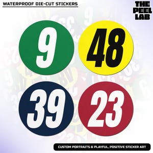 May include: Four waterproof die-cut stickers with large numbers. The stickers are round and in green, yellow, navy blue, and red. The numbers are white and include 9, 48, 39, and 23. The text "WATERPROOF DIE-CUT STICKERS" is at the top.