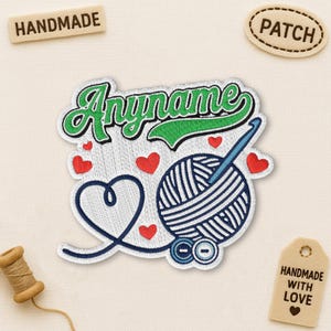 May include: Embroidered patch with a yarn ball, crochet hook, and heart design. The patch features the text "Anyname" in green and white, with small red hearts scattered around the design. Includes a "Handmade" tag.