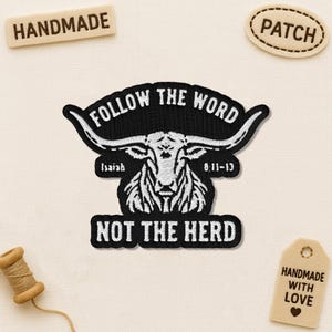 May include: Embroidered patch with a black background and white text that reads "FOLLOW THE WORD" and "NOT THE HERD". The patch features a longhorn skull design. Additional tags say "HANDMADE" and "PATCH".
