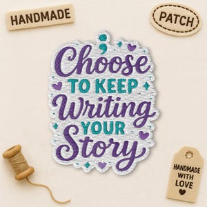 May include: Embroidered patch with the words "Choose to Keep Writing Your Story" in purple and teal. The patch has a wood-grain effect and is surrounded by small hearts and diamonds. There are also small tags that say "Handmade" and "Patch".
