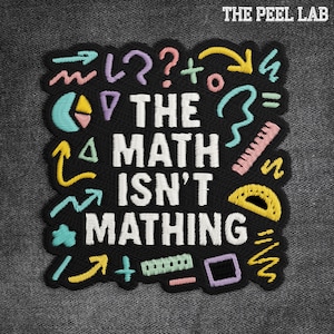 May include: Black embroidered patch with the text "THE MATH ISN'T MATHING" in white. The patch features colorful embroidered math symbols and shapes, including arrows, question marks, and a protractor. The Peel Lab logo is at the top.