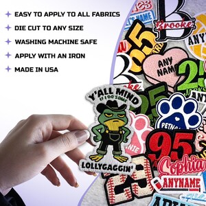 May include: A selection of embroidered patches with diverse designs and text. One patch depicts a frog in overalls and a cowboy hat, with the text "Y'all Mind If I Do Some Lollygaggin'". Other patches include names, numbers, and a baseball.