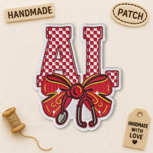 May include: Embroidered patch featuring the letters "AI" in a red and white checkered pattern, connected by a red bow with a stethoscope design. The patch is labeled "HANDMADE" and "PATCH". A tag reads "HANDMADE WITH LOVE".