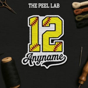 May include: Embroidered patch featuring the number 12 in yellow and white, with red stitching details. The text "Anymame" is below the number. The Peel Lab logo is at the top. The patch is on a black background.