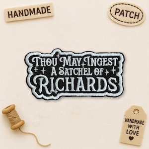 May include: A black and white embroidered patch with the text "THOU MAY INGEST A SATCHEL OF RICHARDS". The patch has a white border. Also shown are small wooden tags that say "HANDMADE", "PATCH", and "HANDMADE WITH LOVE".