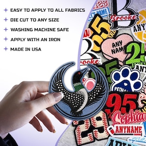 May include: A collection of embroidered fabric patches featuring various designs including a loon, numbers, names, and paw prints. Text on the image reads: EASY TO APPLY TO ALL FABRICS, DIE CUT TO ANY SIZE, WASHING MACHINE SAFE, APPLY WITH AN IRON, MADE IN USA.
