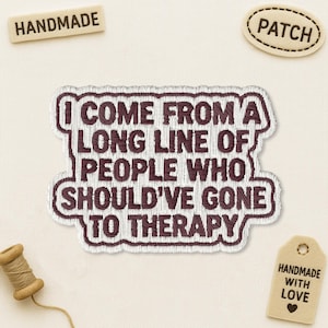 May include: A rectangular embroidered patch with a white background and dark maroon text that reads: I COME FROM A LONG LINE OF PEOPLE WHO SHOULD'VE GONE TO THERAPY. The patch features a thick dark maroon border and a wavy, irregular shape.