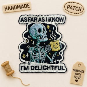 May include: Embroidered patch featuring a teal skeleton holding a yellow mug with a smiling face. The patch reads "AS FAR AS I KNOW I'M DELIGHTFUL" in white text on a black background. Includes "HANDMADE" and "PATCH" tags.