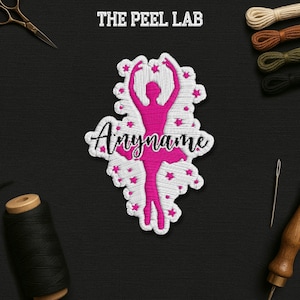 May include: Embroidered patch featuring a pink ballerina silhouette with the name "Anyname" in cursive. The patch is surrounded by white stitching and small pink star accents. The text "THE PEEL LAB" is at the top.