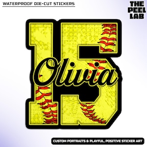 May include: A die-cut sticker featuring the name "Olivia" in a black script font, overlaid on a yellow number "15" with red stitching details, resembling a softball. The sticker has a black border and includes the text "WATERPROOF DIE-CUT STICKERS".