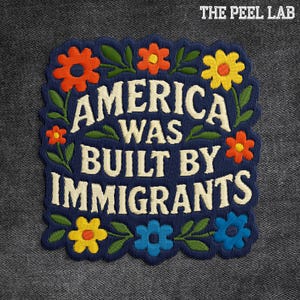 May include: Embroidered patch with the text "AMERICA WAS BUILT BY IMMIGRANTS" in white, surrounded by colorful flowers and green leaves on a navy blue background. The Peel Lab logo is in the top right corner.