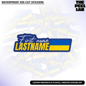 May include: A die-cut sticker with the text "First name LASTNAME" in white and yellow, with a blue border and a blue and yellow flag design. The sticker is labeled "WATERPROOF DIE-CUT STICKERS" and "CUSTOM PORTRAITS & PLAYFUL, POSITIVE STICKER ART".