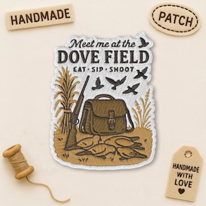 May include: Embroidered patch with the text "Meet me at the Dove Field" and illustrations of birds, a shotgun, and a hunting bag. The patch is brown and beige, with the words "Handmade" and "Patch" on separate tags.