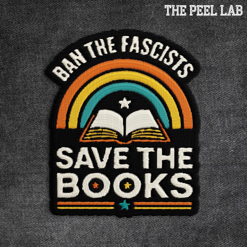May include: Embroidered patch with the text "BAN THE FASCISTS" above a rainbow and an open book, with "SAVE THE BOOKS" below. The patch is black with white, orange, yellow, and teal details. The Peel Lab logo is in the top right corner.