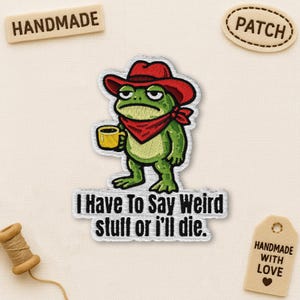 May include: Embroidered patch featuring a green frog wearing a red cowboy hat and bandana, holding a yellow mug. Text on the patch reads "I Have To Say Weird stuff or i'll die." Includes "HANDMADE" and "PATCH" tags.
