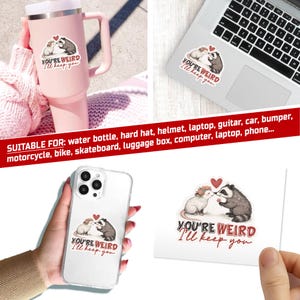 May include: A sticker featuring a rat and a raccoon kissing, with a red heart above them. The text "YOU'RE WEIRD I'LL KEEP YOU" is below the image. The sticker is shown on a water bottle, laptop, phone case, and a loose sticker.