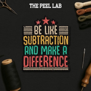 May include: Embroidered patch with the text "BE LIKE SUBTRACTION AND MAKE A DIFFERENCE" in yellow, teal, and red. The patch is black with a white border and star accents. The Peel Lab logo is at the top.