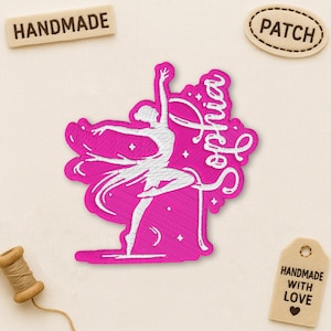 May include: A pink embroidered patch featuring a ballerina in a graceful pose, with the name "Sophia" in cursive script. The patch is surrounded by a decorative border. Additional tags read "HANDMADE", "PATCH", and "HANDMADE WITH LOVE".