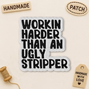 May include: Embroidered patch with the phrase "Workin' Harder Than An Ugly Stripper" in black on white. Additional small patches read "Handmade" and "Patch". A small tag reads "Handmade With Love".