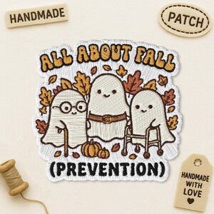 May include: An embroidered patch featuring three white ghosts surrounded by orange and brown autumn leaves and pumpkins. The text reads ALL ABOUT FALL (PREVENTION). One ghost wears glasses and uses a cane, while another uses a walker.