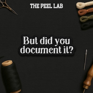 May include: Black embroidered patch with the text "But did you document it?" in white. The patch is surrounded by sewing supplies, including thread, scissors, and a needle, against a black background. The text "THE PEEL LAB" is at the top.