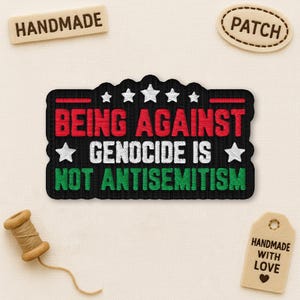 May include: Embroidered patch with the text "BEING AGAINST GENOCIDE IS NOT ANTISEMITISM" in red, white, and green on a black background. The patch has a star design and is surrounded by a black border. Includes "HANDMADE" and "PATCH" tags.