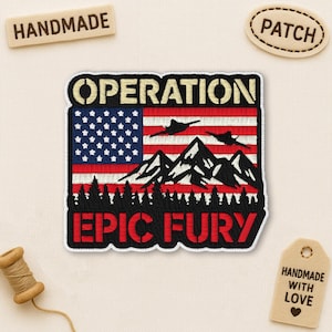 May include: Embroidered patch featuring an American flag design with mountains, jets, and the text "OPERATION EPIC FURY." The patch is black, red, white, and blue, with a stitched border. Handmade with love.