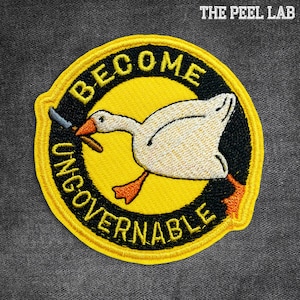 May include: Embroidered patch with a yellow border, featuring a white goose holding a knife. The goose is inside a yellow circle with the words "BECOME UNGOVERNABLE" in yellow text. The Peel Lab text is in the top right corner.