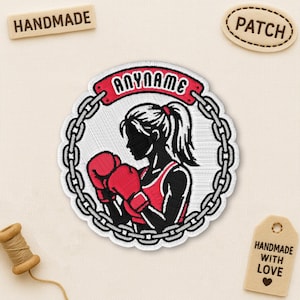 May include: Embroidered patch featuring a female boxer in a red tank top and boxing gloves, encircled by a chain design. The patch includes the text "ANYNAME" on a red banner. Additional tags read "HANDMADE" and "PATCH".